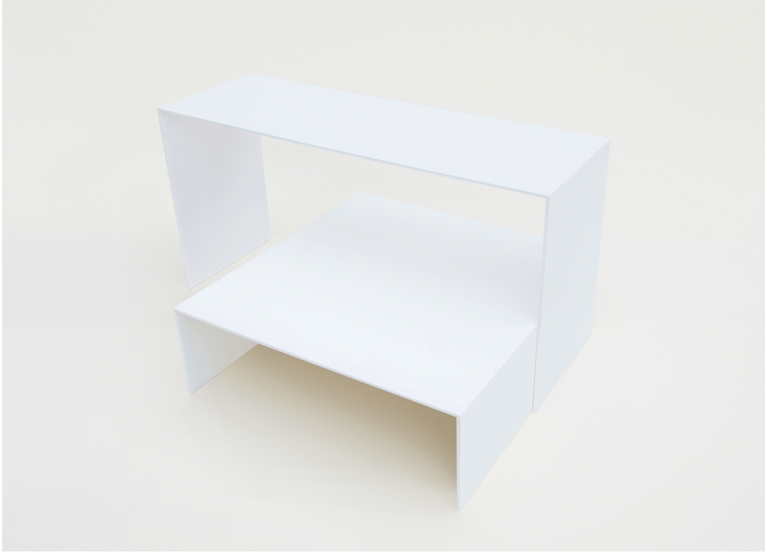 Close-up of a minimalist white bed platform, focusing on the edge of the platform and two of the vertical support panels underneath.